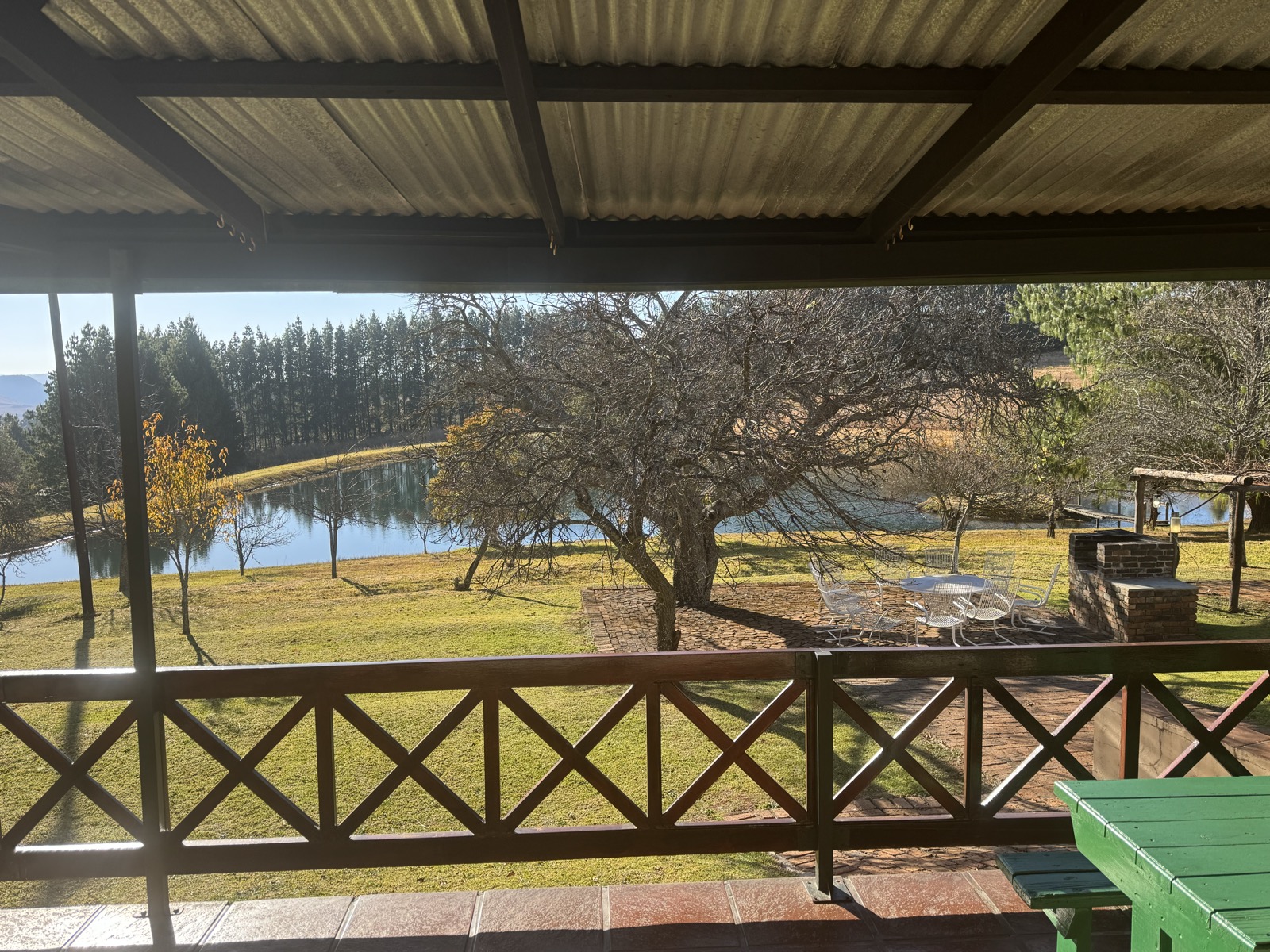 View from the stoep overlooking the garden, braai area, and trout dam